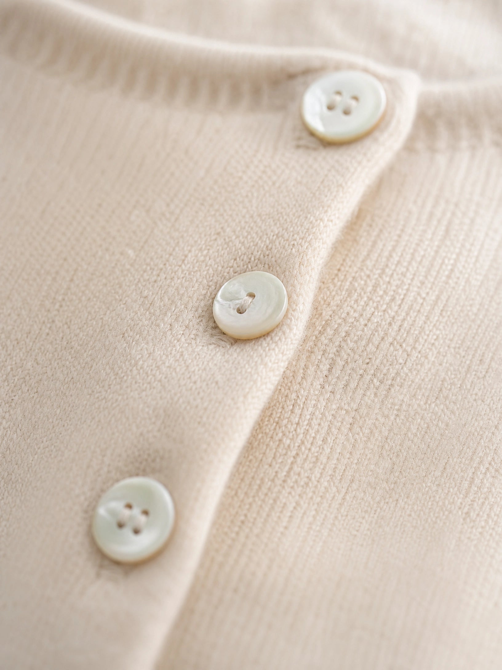 grey asymmetric knit sweater Averly London button detail close-up